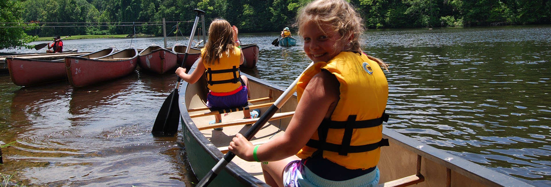2 girls in a canoe on the lake