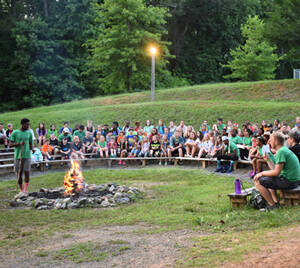 Group hanging out around at the campfire circle.