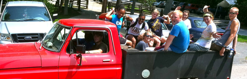 group of counselors in the back of a truck making funny faces