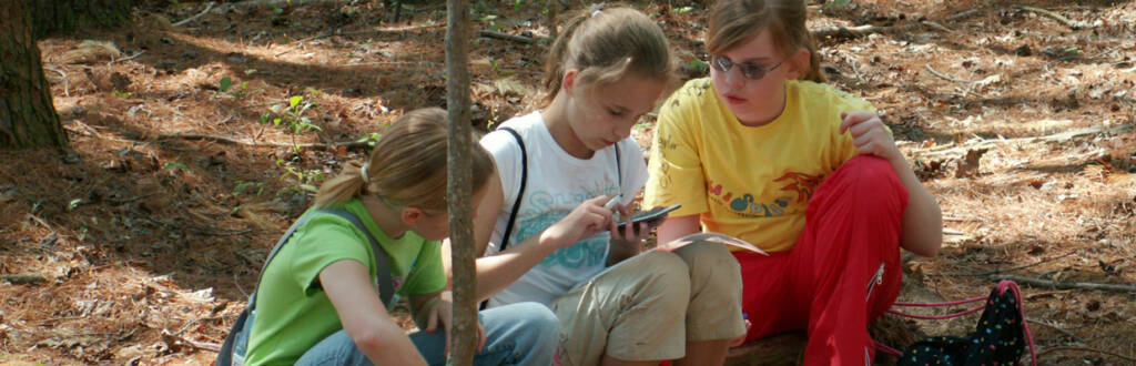 girls looking at a compass