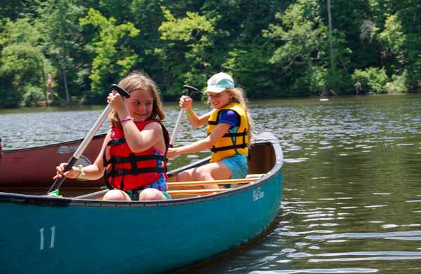 Two girls starting to paddle on the lake