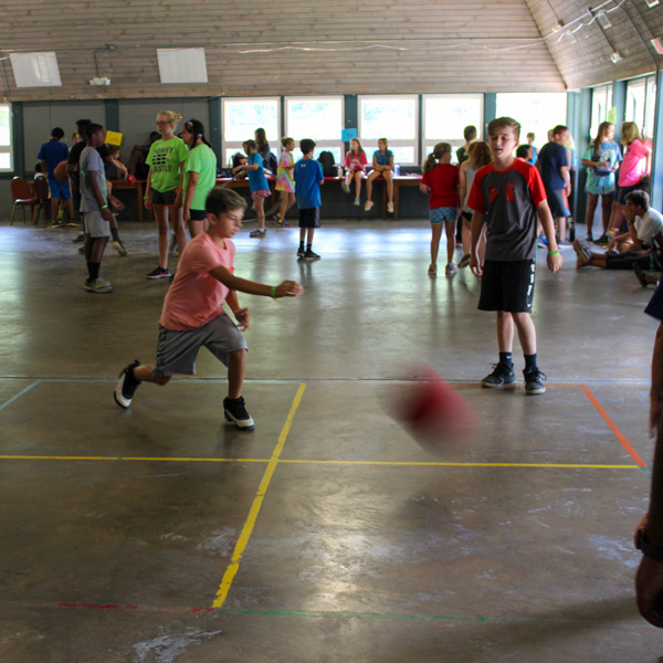 group kicking a ball in the rec hall