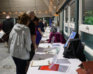 People looking at silent auction items