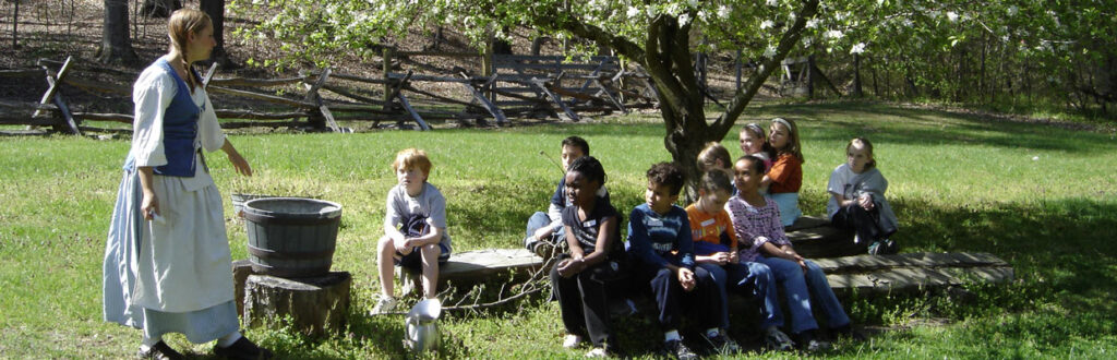 youth watching candle making outside