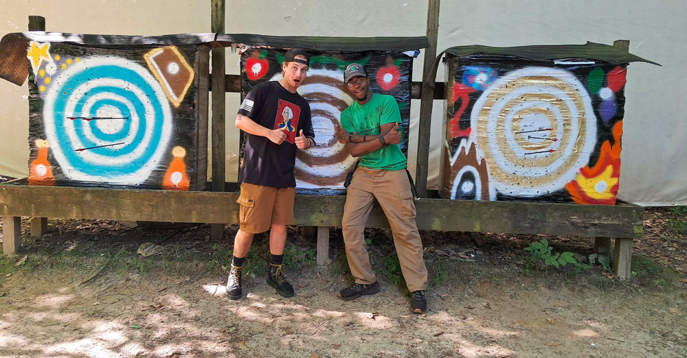 counselors standing in front of arrow boards