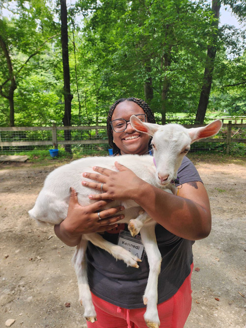 counselor holding a baby goat