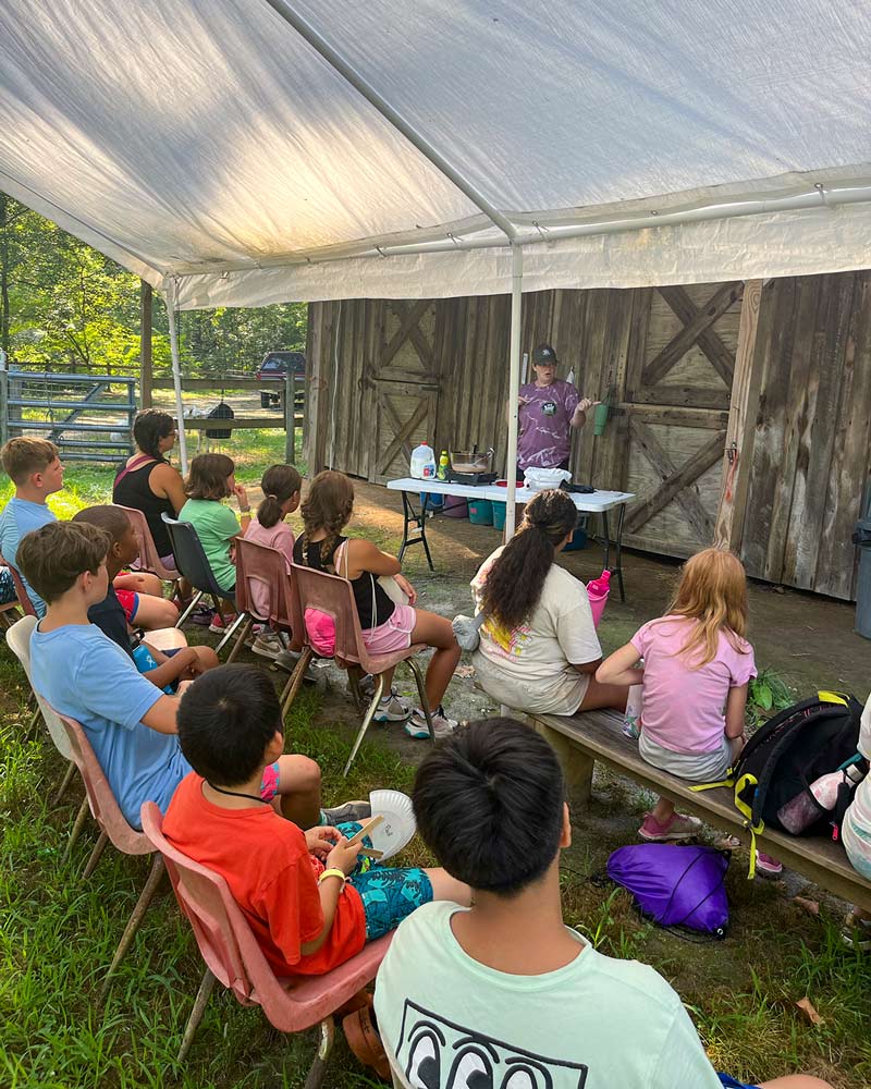 youth learning from counselor outside