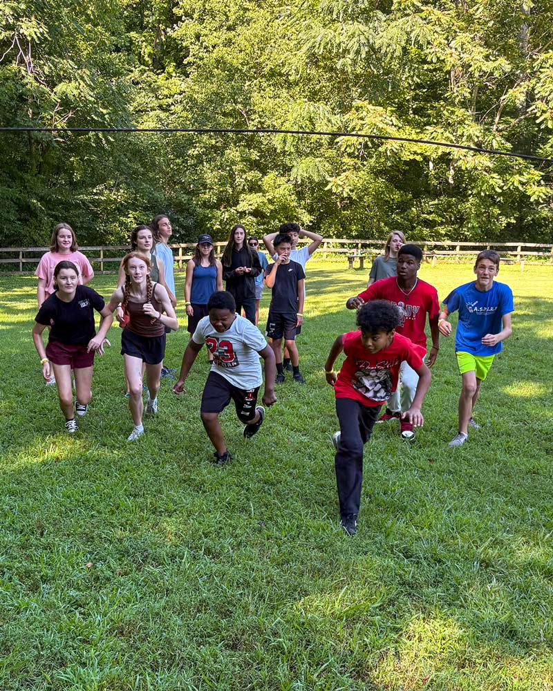 youth running on grass during a game