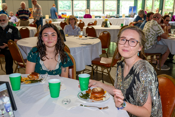 two ladies at table eating bbq