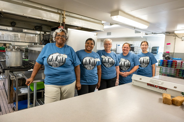 Staff standing in cafeteria