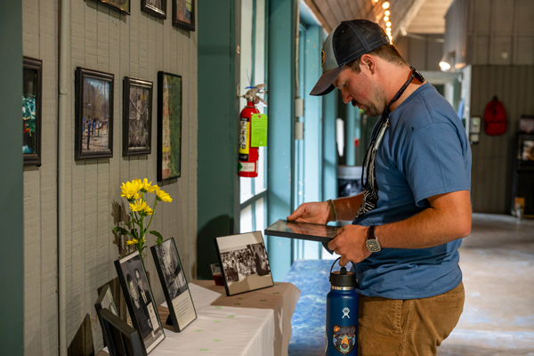 staff member looking at old photos out for display